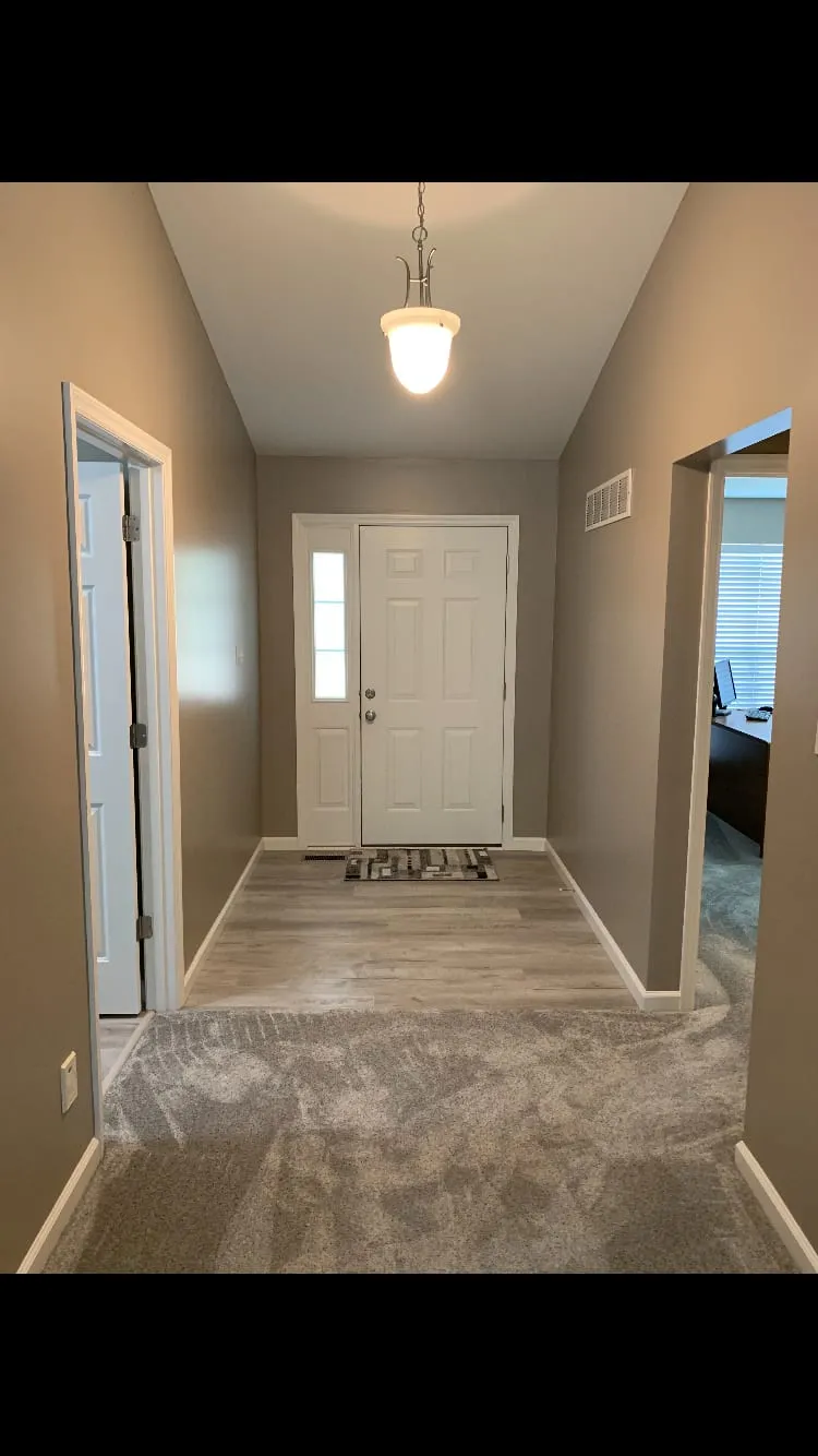Bright, freshly painted entry hall by the front door