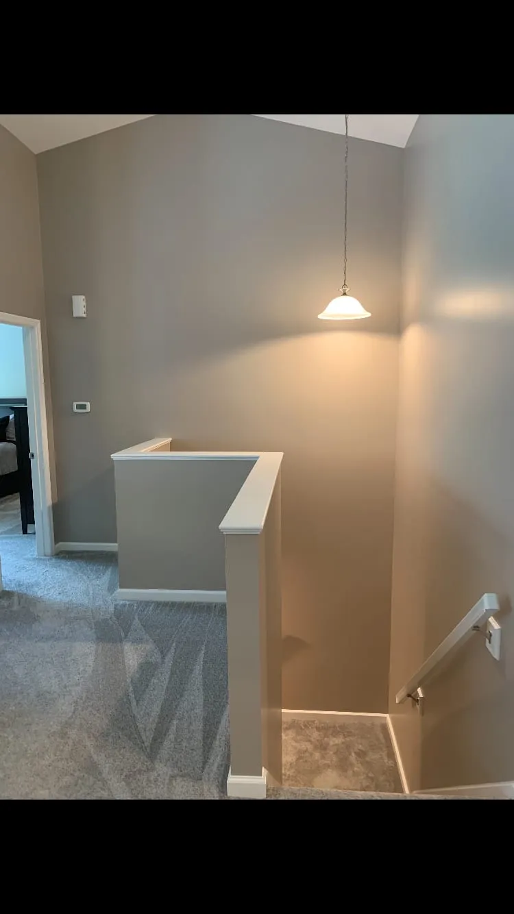 Bright stair landing painted in a warm greige